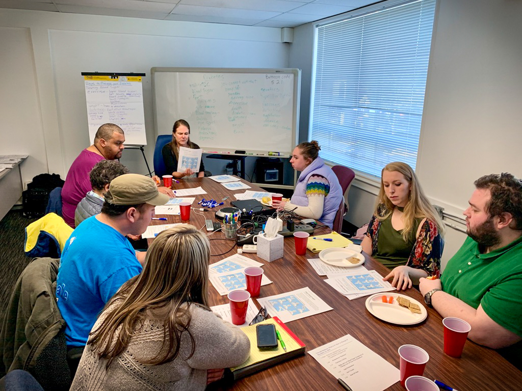 a picture showing feedback being gathered on Cognitopia's My Life Portfolio tools during a meeting at Oregon Health Sciences University